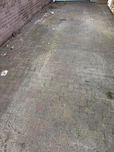 Driveway before cleaning with dirt, weeds and tired block paving joints